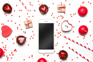 Flatlay with confetti heart & phone featuring anniversary, ad, and birthday