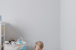Little boy toddler playing with childrens multi-colored developing pyramid. Hom