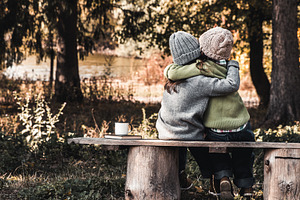 Two happy girls as friends hug each