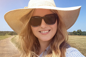 Country path stroll on a bright summer day, woman in straw hat a, a Person Photo by Studio ANNA