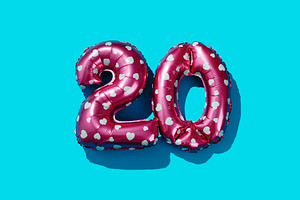 pink balloons forming the number 20 on blue, a Photo by Nito