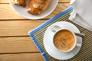Breakfast with a coffee on wooden table with pastries, a Food & Drink Photo by Davizro's Market