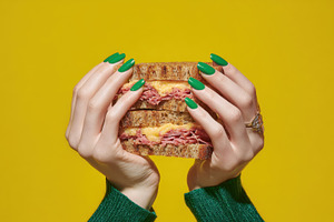 Hands with sandwich on yellow, a Photo by Beautiful things