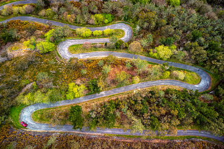 Aerial view curve road on the mountains in Asturias, Spain., a Transportation Photo by CreativePhotoSpain
