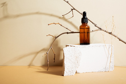 Bottle dark glass with dropper on beige background. Natural cosm, a Beauty & Fashion Photo by matucha