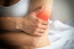 Woman Holding Painful Elbow with Red Highlight, a Health & Medical Photo by Davizro's Market
