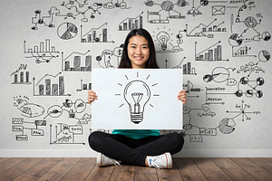 Woman Holding Light Bulb Sign, a Business Photo by Stock Shape