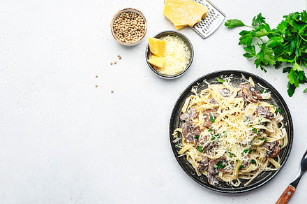 Tagliatelle pasta with mushrooms and parmesan cheese on plate wi, a Food & Drink Photo by 5PH
