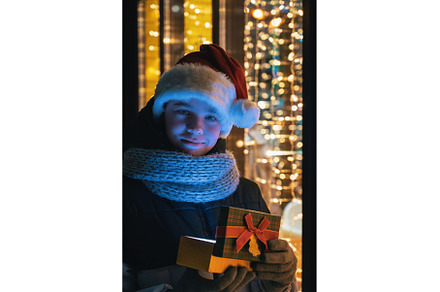 Boy in Santas hat with gifts box, a Person Photo by Jan Jack Russo Media