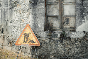 Roadwork sign by stone wall, a Transportation Photo by SkyNext