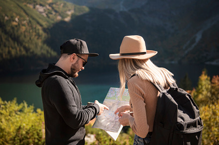 Young tourist couple, man and woman, on hiking path in mountains, a Person Photo by Olena Rudo