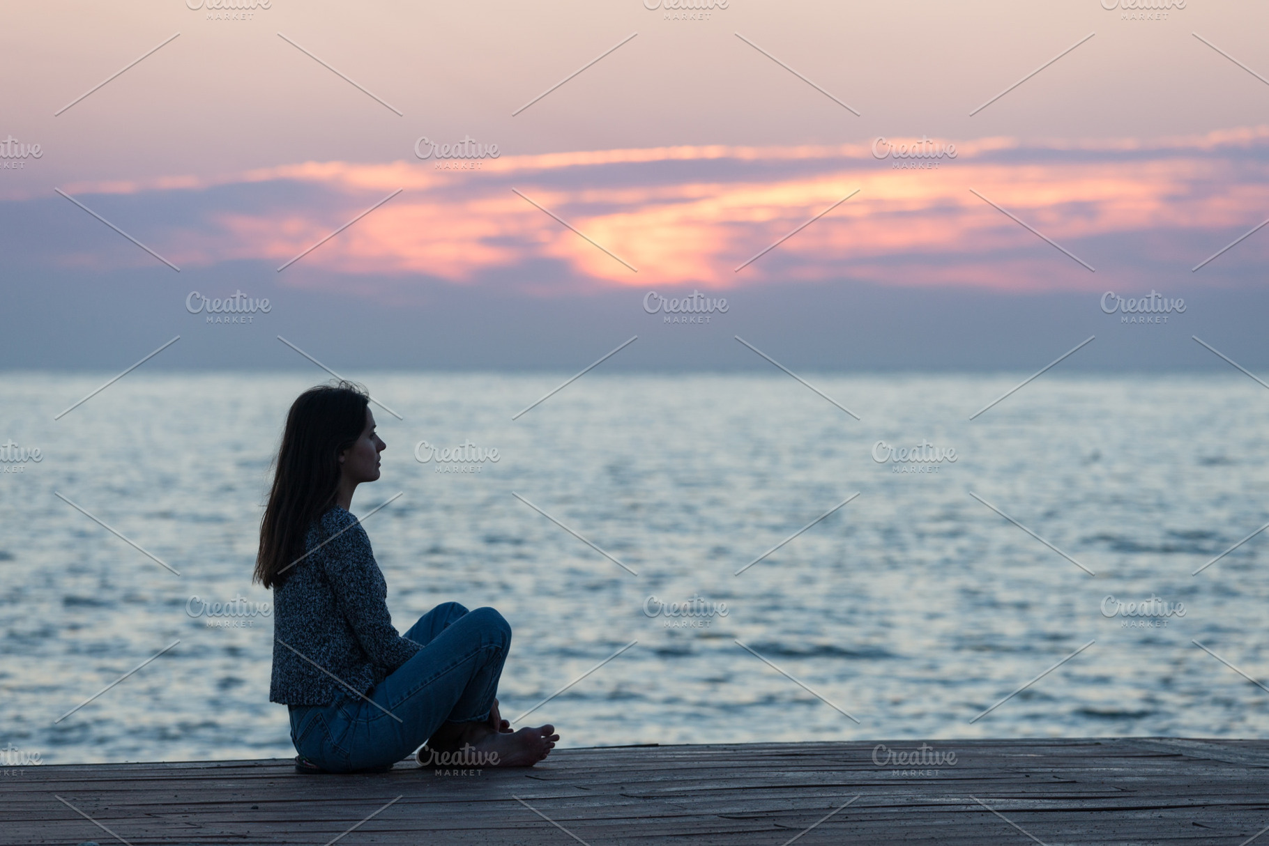 Lonely girl sitting on the sunrise containing woman, silhouette, and beach, a Person Photo by khoroshkov
