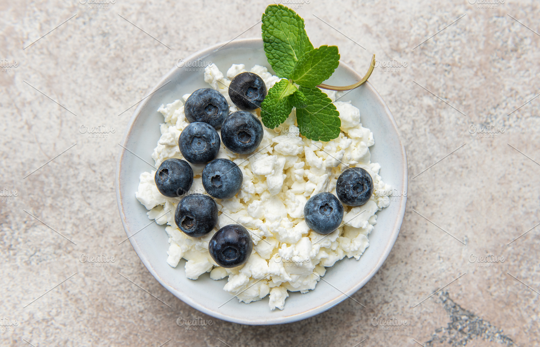 Cottage cheese bowl with fresh blueberries and mint, a Food & Drink Photo by Olena Rudo