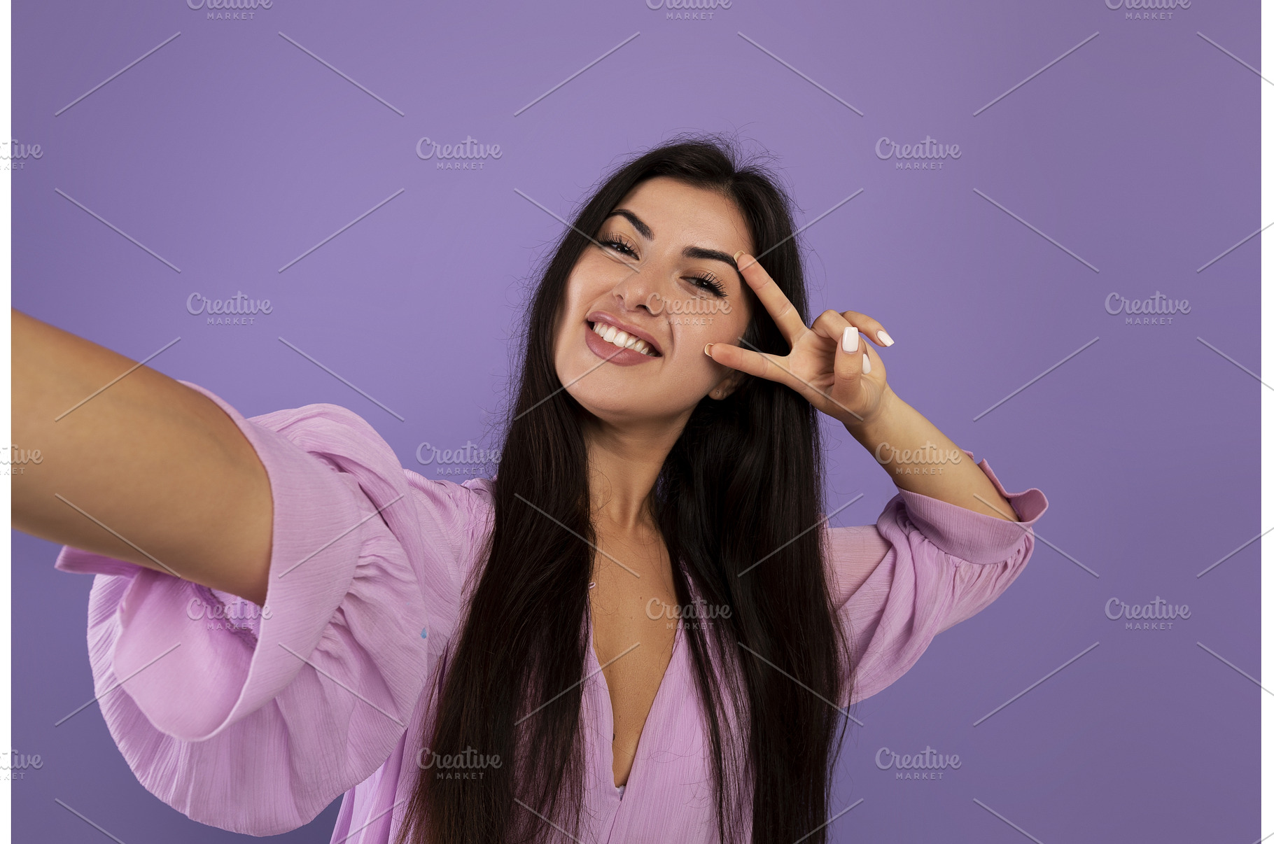 Joyful armenian woman taking selfie, a Person Photo by Prostock-Studio