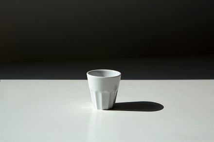 White small coffee mug withouthandle, a Photo by UN-BRANDED