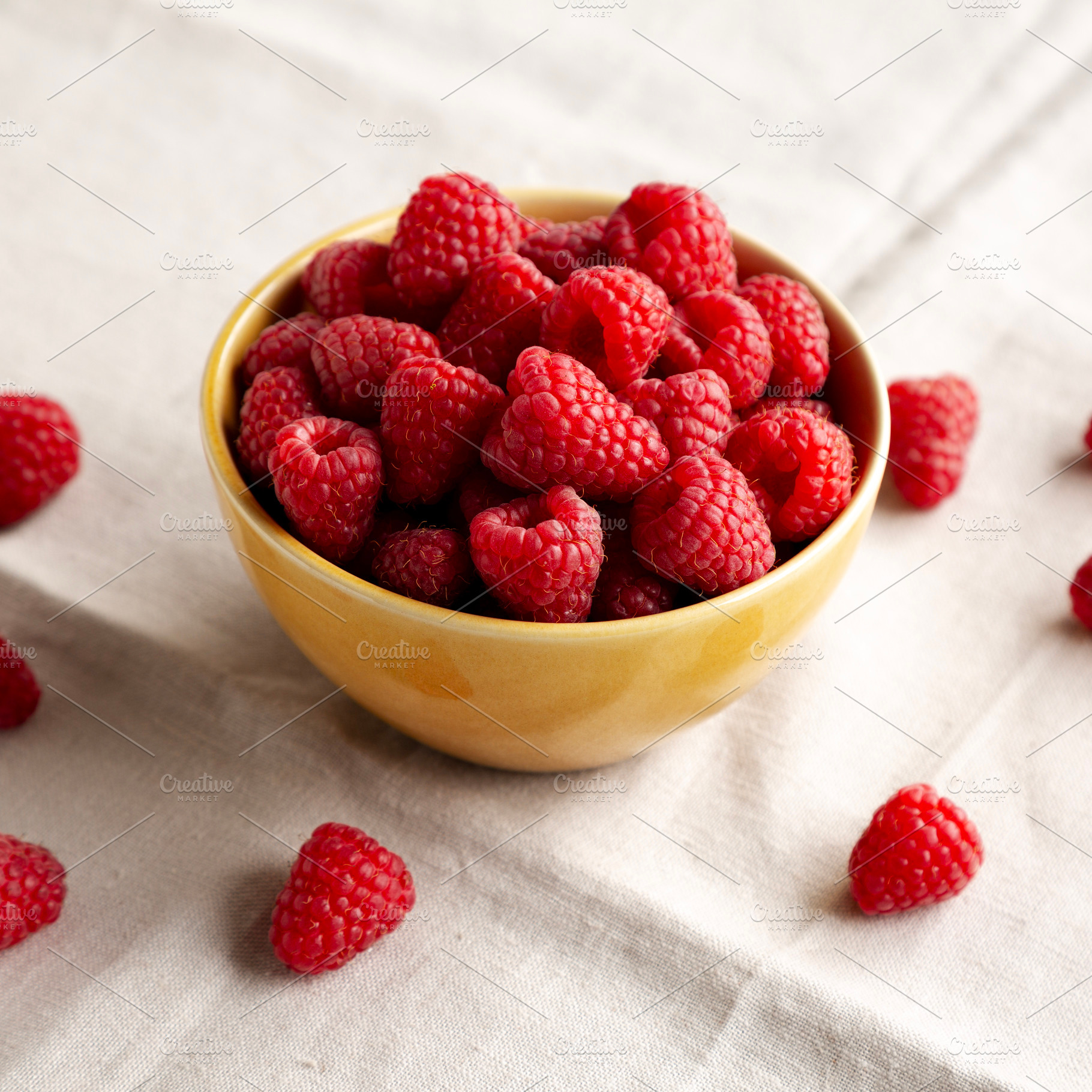 Organic Raw Red Raspberries in a Bowl, side view., a Food & Drink Photo by LiudmylaChuhunova