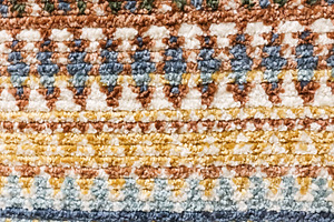 Colorful woven carpet showing intricate bohemian striped pattern and rich texti, a Photo by Studio ANNA