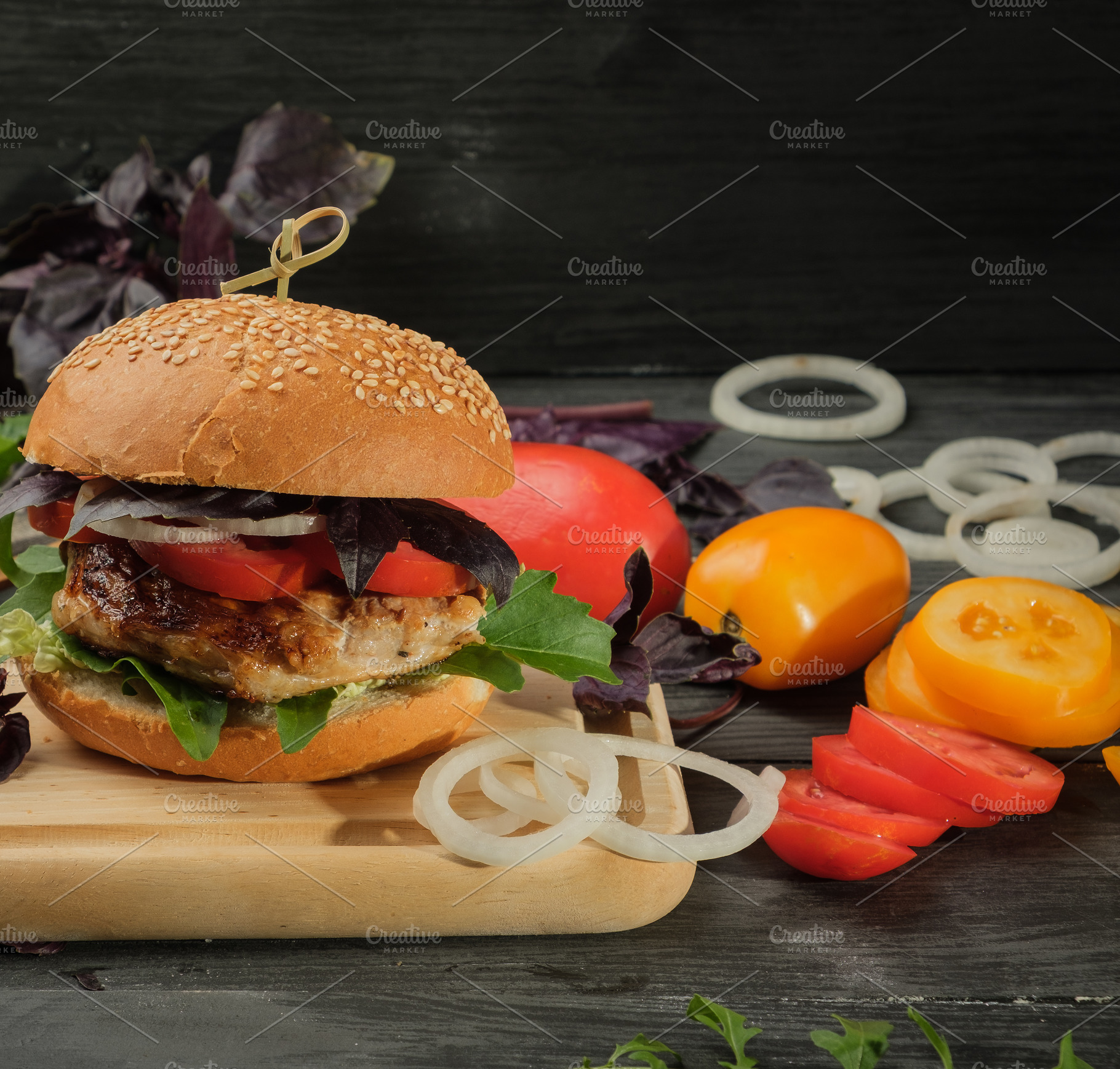 Hamburger with pork steak and vegetables on a wooden board, a Food & Drink Photo by ndanko