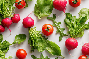 Fresh salad ingredients including vibrant lettuce and arugula with ripe tomatoe, a Food & Drink Photo by AlyaAnd