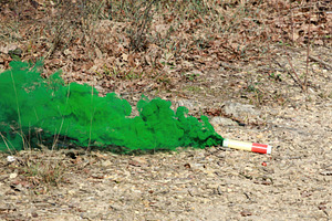 Green smoke grenade emitting thick colored smoke in a forest, a Sports & Recreation Photo by Antonio Gravante Market