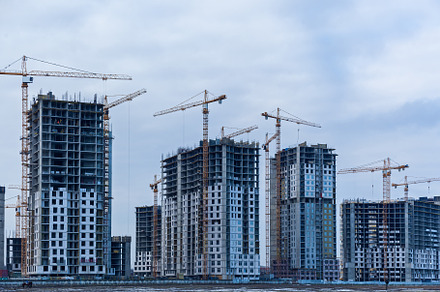 Construction site of multi-storey houses and building cranes, an Industrial Photo by Photostock
