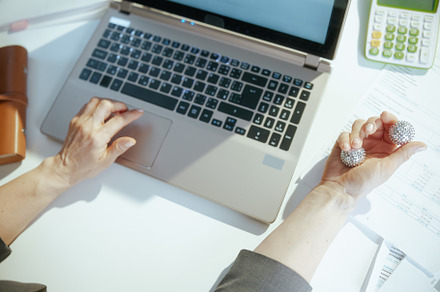 Modern business owner woman in grey business suit at work, a Health & Medical Photo by Alliance Images