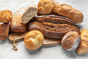 Assortment of fresh baked crusty artisan bread and croissants, a Food & Drink Photo by Olena Rudo