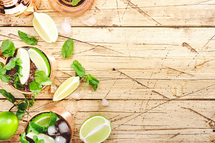 Moscow mule cocktails in copper mug with lime, ice, ginger beer,, a Food & Drink Photo by 5PH