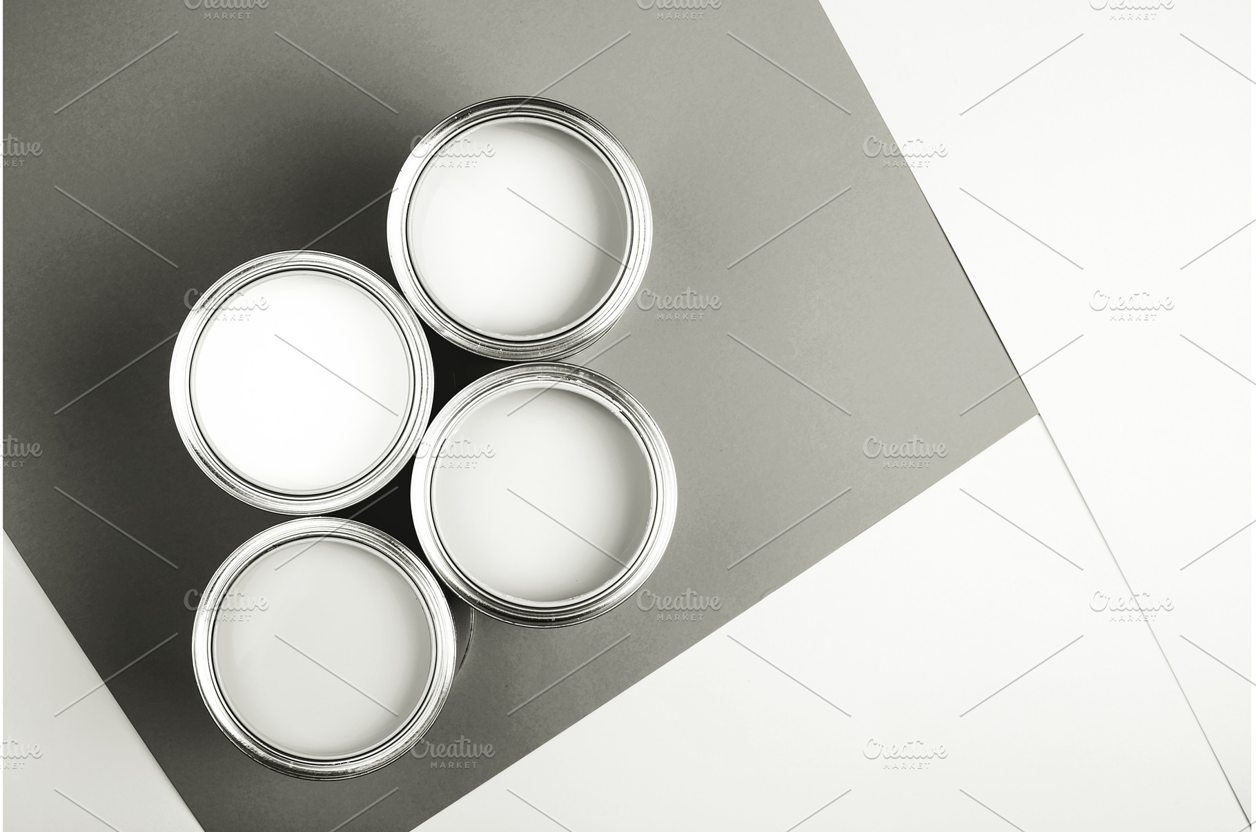 White paint cans on a gray and white, a Background Photo by Anna Efetova
