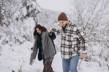 A young happy and loving couple walking in a snowy forest in the, a Person Photo by Cherkas Photography