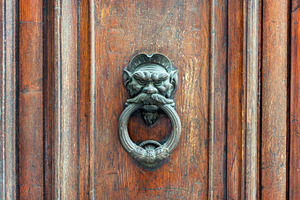 Iron lion doorknob on wooden door, an Architecture Photo by BOOCYS