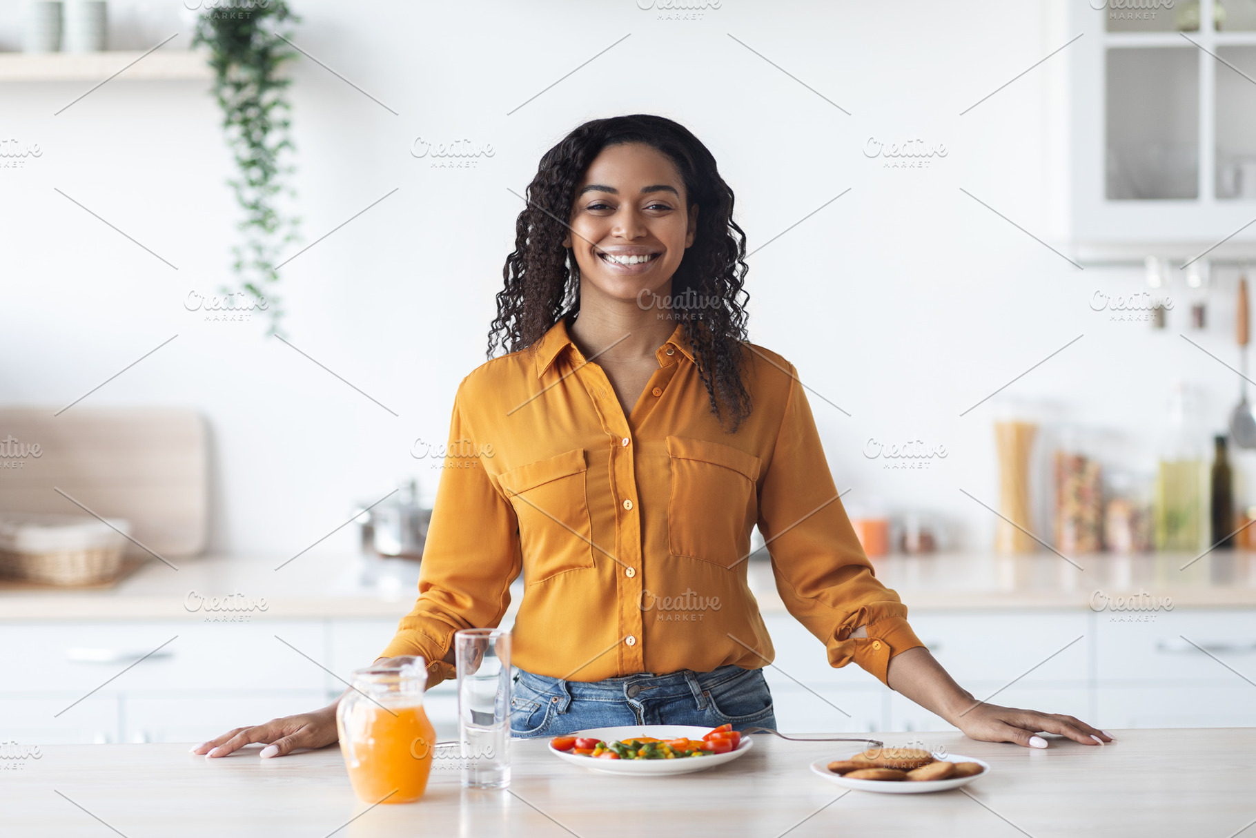 Cheerful black woman having proper breakfast, kitchen interior, a Photo by Prostock-Studio