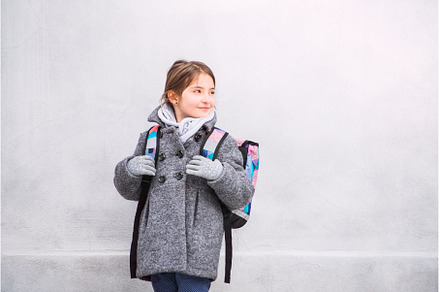 Portrait of schoolgirl in coat in, a School & Education Photo by HalfPoint