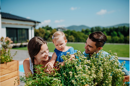 Young family taking care of plants