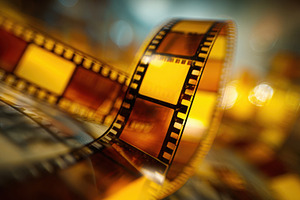 Film reel rolls across surface, a Photo by Beautiful things