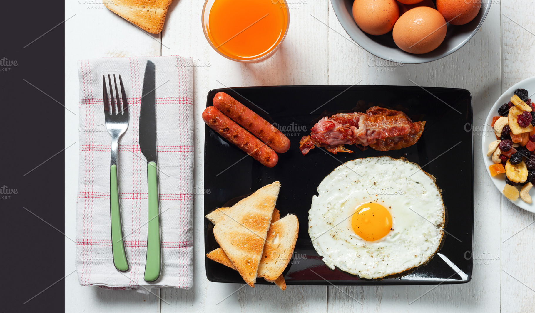Delicious full english breakfast with fried egg, bacon, sausages and toasts on, a Food & Drink Photo by Antonio Gravante Market