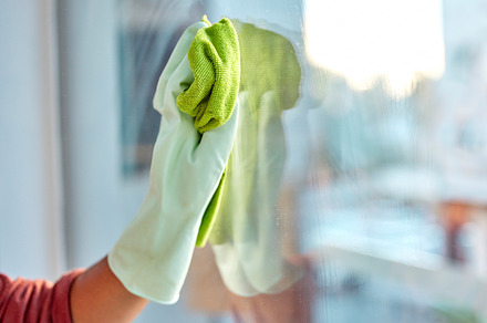 Hand, latex and cloth for window cleaning, hygiene or clean housework and disinfection at home. Hands of cleaner wiping dirty glass for cleanliness, disinfect or anti bacteria and safe housekeeping, a Photo by Peopleimages.com