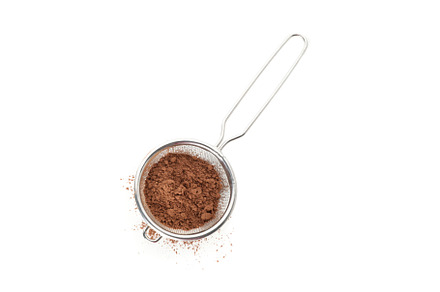 Strainer with cocoa powder isolated on white background, a Food & Drink Photo by AtlasStudio