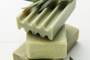 Olive soap bars forming a stack with olive branch on top, a Health & Medical Photo by Olena Rudo