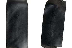 Two vertical pieces of black electrical tape with torn edges on, an Industrial Photo by ndanko