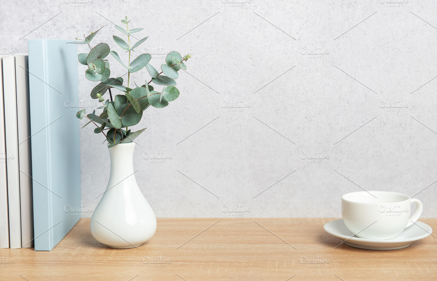 Eucalyptus branches, books, and coffee cup creating a cozy atmos, a Background Photo by Olena Rudo