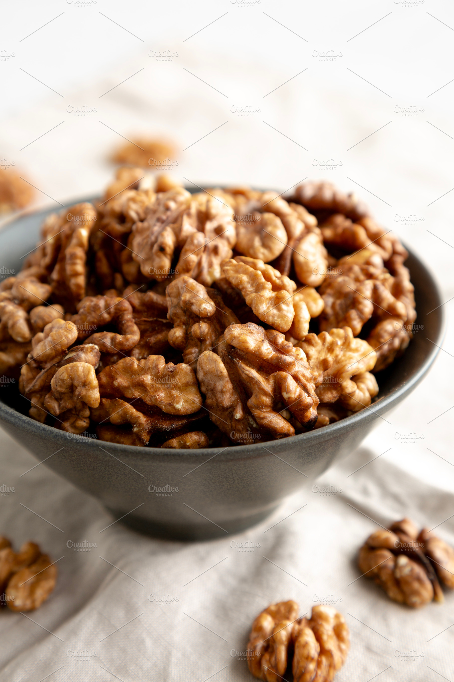 Raw Walnut Halfs in a Bowl, side view. Close-up., a Food & Drink Photo by LiudmylaChuhunova