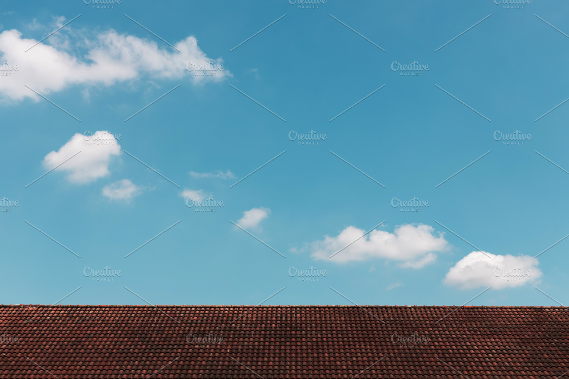 Clouds in the Blue Sky on Sunny Day over Red rooftop, a Photo by salmon.black