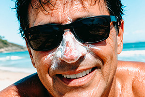 a man relaxes with sunscreen by sea, generative AI, a Photo by Nito