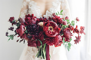 Wedding bouquet of dark red peonies