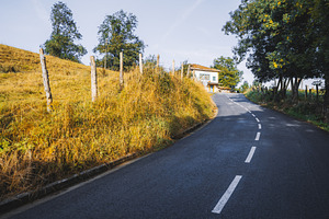 Rural curved road in autumn, a Transportation Photo by SkyNext