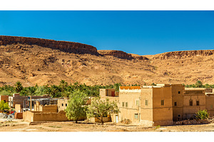 A village with traditional kasbah houses in ziz valley morocco featuring, an Architecture Photo by Leonid Andronov