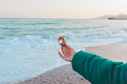Girl holding sea shell at winter 