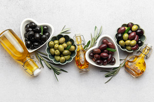 Black, green and kalamata olives with olive oil and olive branch, a Food & Drink Photo by Olena Rudo