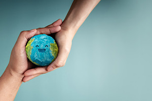 two people holding Happy Smiling Earth symbolizing sustainabilit, a Photo by salmon.black